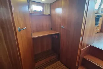 Interior of 2008 Linssen 33.9 AC yacht with wooden cabinetry and shelving.