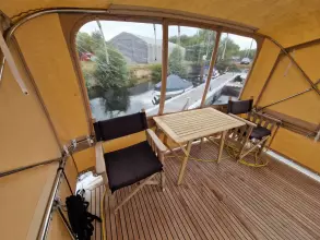 Interior of 2008 Linssen 33.9 AC yacht with wooden deck and seating area.