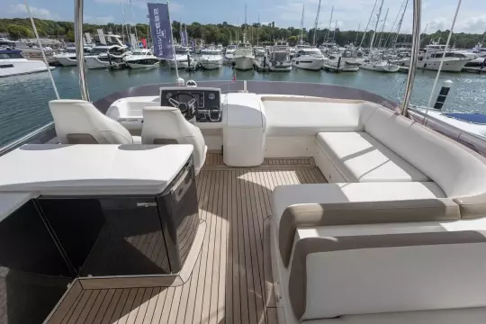 Luxurious 2015 Princess 60 yacht interior with elegant seating and marina view.