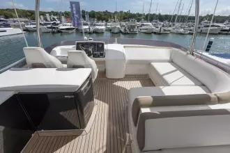 Luxurious 2015 Princess 60 yacht interior with elegant seating and marina view.