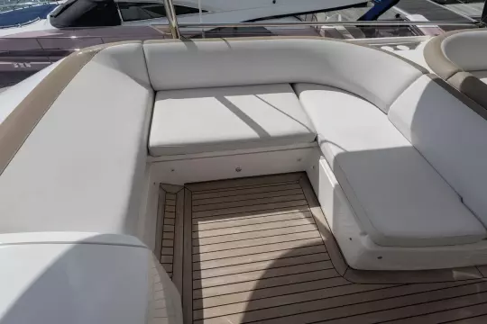 Luxurious seating area on a 2015 Princess 60 yacht with elegant white cushions.