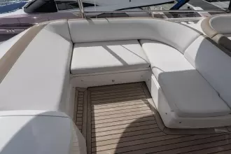 Luxurious seating area on a 2015 Princess 60 yacht with elegant white cushions.