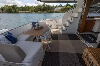 Luxurious 2015 Princess 60 yacht deck with elegant seating and scenic water view.