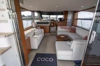 Luxurious interior of 2015 Princess 60 yacht with elegant seating and scenic water views.
