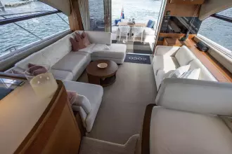 Luxurious interior of a 2015 Princess 60 yacht with elegant seating and waterfront view.