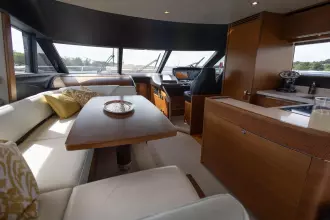Luxurious interior of a 2015 Princess 60 yacht with elegant seating and modern amenities.