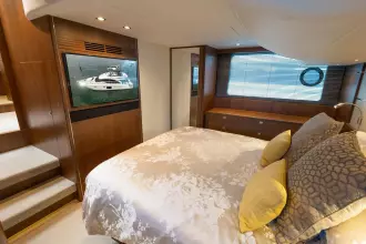 Luxurious bedroom interior of 2015 Princess 60 yacht with elegant decor and modern amenities.