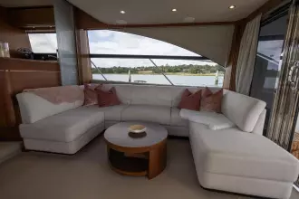 Luxurious interior of 2015 Princess 60 yacht with elegant seating and scenic water view.