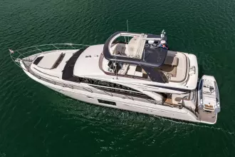 Aerial view of 2015 Princess 60 yacht cruising on open water.