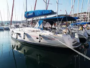 2013 Jeanneau Sun Odyssey 469 sailboat docked in marina, featuring blue sail cover.