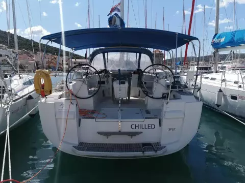 2013 Jeanneau Sun Odyssey 469 sailboat docked in marina, rear view.