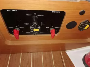 Control panel of a 2013 Jeanneau Sun Odyssey 469 sailboat with battery and breaker switches.