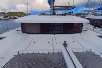 2020 Lagoon 42 catamaran docked in a marina, showcasing sleek design and spacious deck.