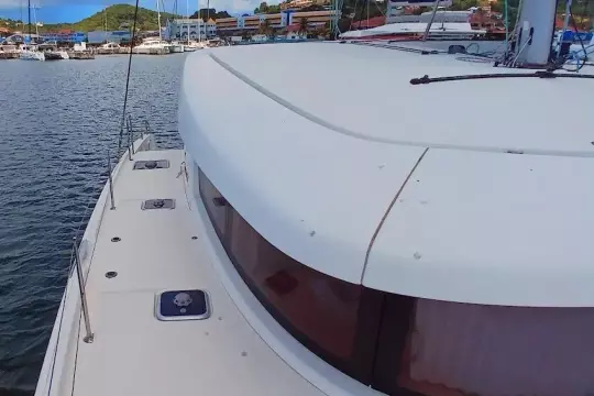 2020 Lagoon 42 catamaran docked at marina, showcasing sleek design and spacious deck.