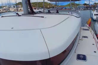 2020 Lagoon 42 catamaran docked in a marina, showcasing sleek design and spacious deck.