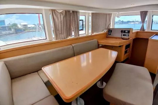 Interior of 2020 Lagoon 42 catamaran with dining area and navigation station.