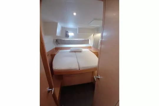 Cozy cabin interior of 2020 Lagoon 42 catamaran with comfortable bed and natural light.