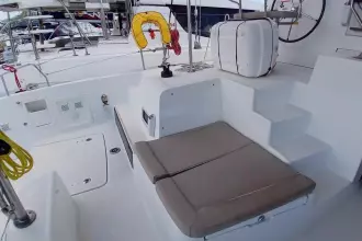 2020 Lagoon 42 catamaran cockpit with seating, steps, and safety equipment.