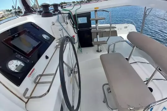 Helm station of 2020 Lagoon 42 catamaran with navigation equipment and seating.
