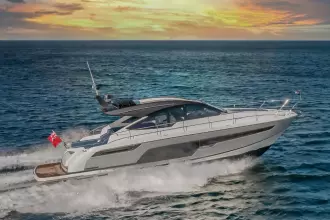 2025 Fairline Targa 50 Open yacht cruising at sunset on the ocean.