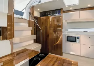 Luxurious 2025 Fairline Targa 50 Open yacht interior with modern kitchen and wooden finishes.