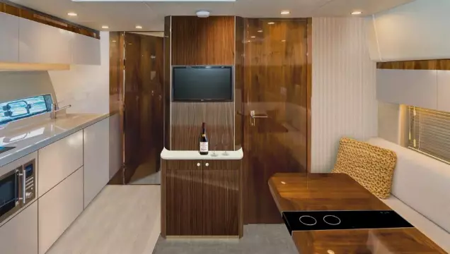 Luxurious interior of 2025 Fairline Targa 50 Open yacht with modern kitchen and dining area.