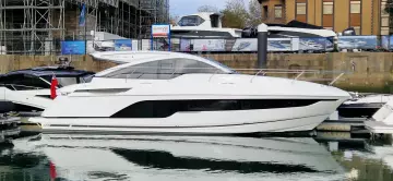 2025 Fairline Targa 45 Open yacht docked in a marina, showcasing sleek design and luxury.