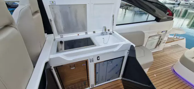 2025 Fairline Targa 45 Open yacht kitchenette with sink and storage, featuring sleek design.