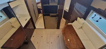 2025 Fairline Targa 45 Open interior with elegant seating and wooden table.