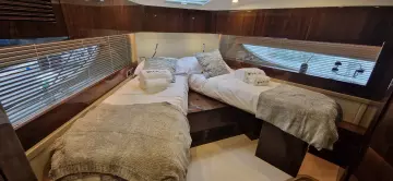 Luxurious cabin interior of 2025 Fairline Targa 45 Open yacht with twin beds.