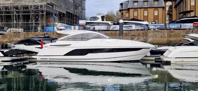 2025 Fairline Targa 45 Open yacht docked in a marina, reflecting on calm water.