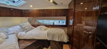 Luxurious cabin interior of 2025 Fairline Targa 45 Open yacht, featuring elegant wood finishes.