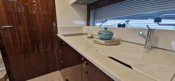 Luxurious kitchen interior of 2025 Fairline Targa 45 Open yacht with modern amenities.