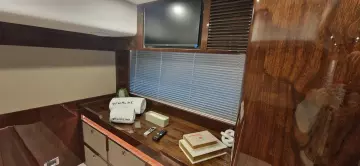 Luxurious interior of 2025 Fairline Targa 45 Open yacht with TV and wooden cabinetry.