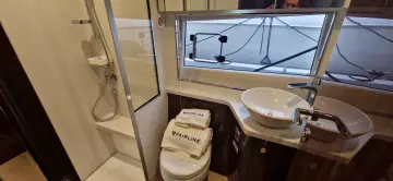 Bathroom interior of 2025 Fairline Targa 45 Open yacht, featuring modern fixtures and branded towels.