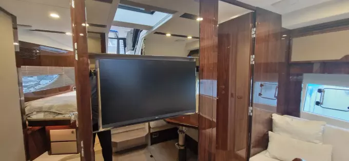 2025 Fairline Targa 45 Open interior with modern design, featuring a TV and luxurious furnishings.