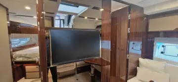 2025 Fairline Targa 45 Open interior with modern design, featuring a TV and luxurious furnishings.