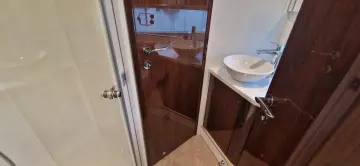 2025 Fairline Targa 45 Open bathroom with modern sink and wooden cabinetry.