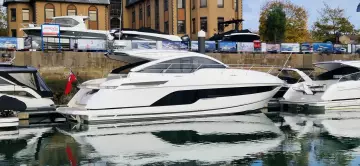 2025 Fairline Targa 45 Open yacht docked in a marina, reflecting on the water.