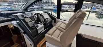 2025 Fairline Targa 45 Open cockpit with modern controls and luxurious seating at marina.