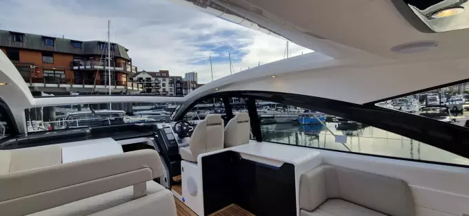 2025 Fairline Targa 45 Open yacht interior with marina view, featuring sleek design and comfortable seating.
