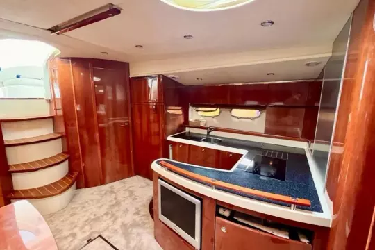 Interior of 2006 Fairline Targa 52 GT yacht with modern kitchen and wooden finishes.