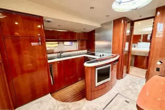 Luxurious 2006 Fairline Targa 52 GT yacht interior with modern kitchen and elegant wood finishes.
