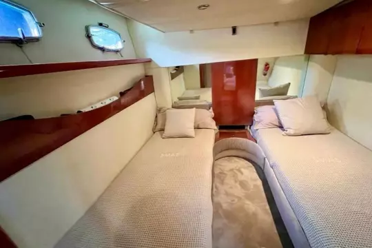 Interior cabin of 2006 Fairline Targa 52 GT yacht with twin beds and elegant decor.