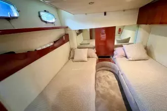 Interior cabin of 2006 Fairline Targa 52 GT yacht with twin beds and elegant decor.