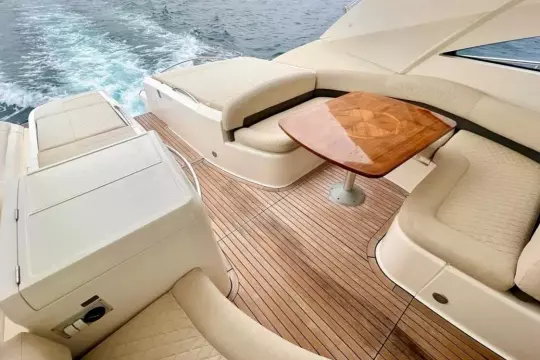 Luxurious 2006 Fairline Targa 52 GT yacht interior with elegant seating and wooden table.