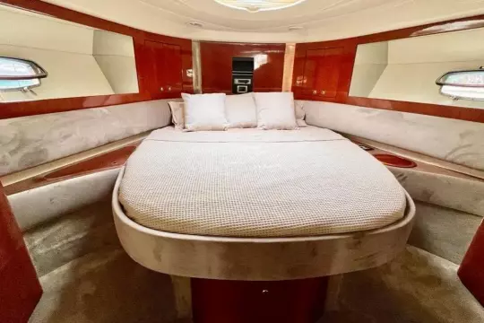 Luxurious cabin interior of 2006 Fairline Targa 52 GT yacht with elegant bedding.