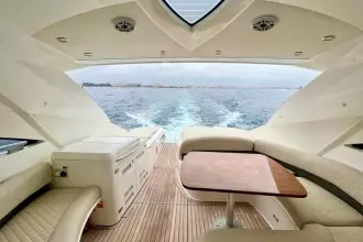 Luxurious 2006 Fairline Targa 52 GT yacht interior with ocean view and elegant seating.