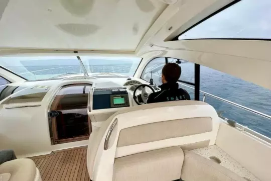 Interior view of 2006 Fairline Targa 52 GT yacht with person at helm.