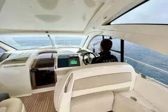 Interior view of 2006 Fairline Targa 52 GT yacht with person at helm.